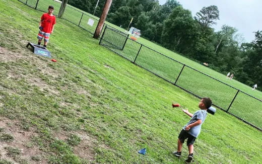 a group of people play baseball
