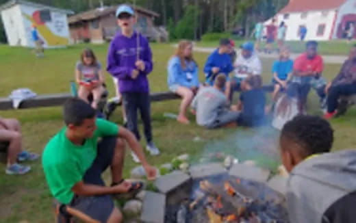 a group of people sitting around a fire