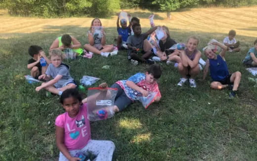 a group of people sitting on the grass