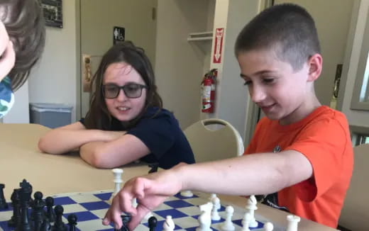 a group of people playing chess