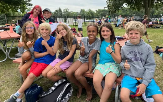 a group of people sitting together outside