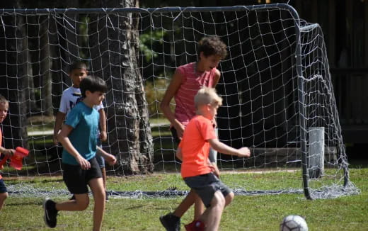 kids playing football in a field