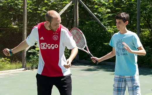 a couple of men playing tennis