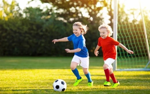 two kids playing football