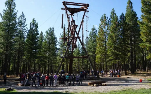 a group of people standing next to a tower