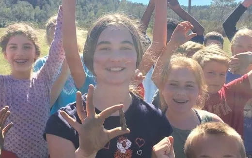 a group of people holding their hands up