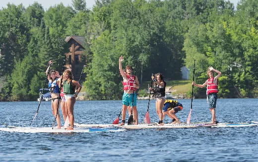 a group of people on a paddle board