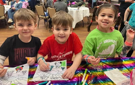a group of children sitting at a table