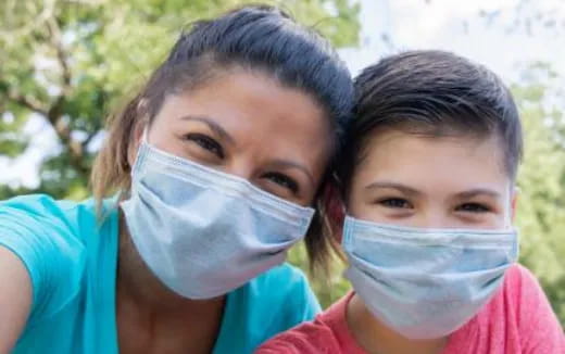 a person and a child wearing face masks