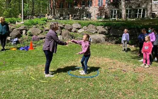a group of people playing in a grassy field