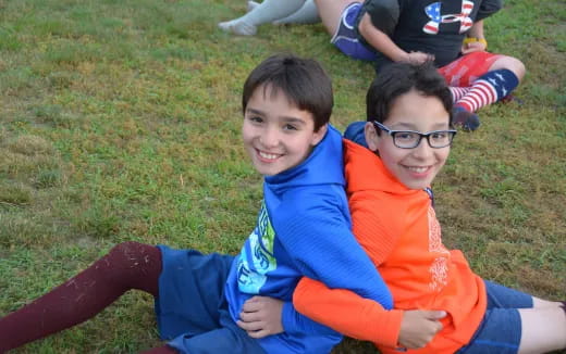 a group of boys lying on the grass