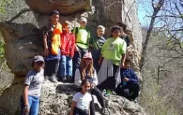 a group of people standing on a rock