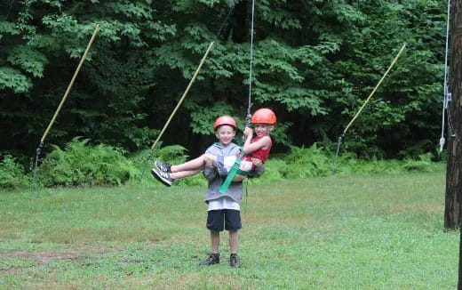 a man and a boy on a swing set