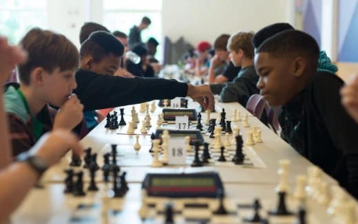 a group of people playing chess