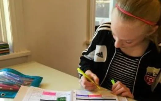 a young girl coloring on a paper