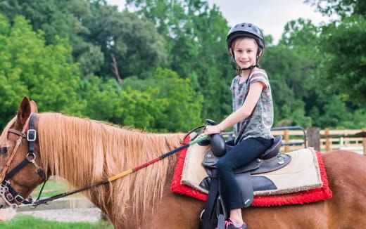 a girl riding a horse
