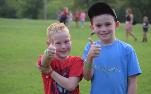 two boys making hand gestures