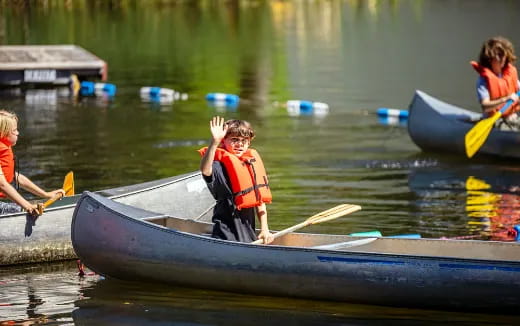 a group of people rowing a boat