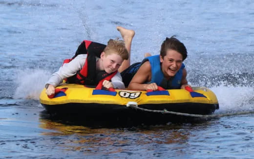 a person and a boy on a raft in the water