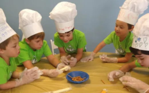 a group of kids wearing white hats