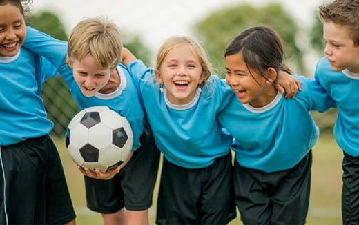 a group of kids playing football