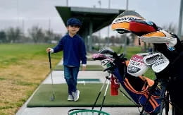 a boy playing golf