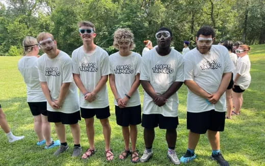 a group of people wearing white shirts