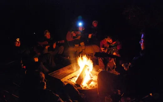 a group of people around a fire