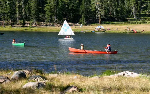 people in boats on a lake