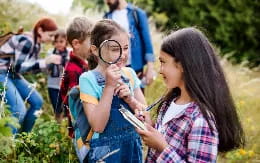 a group of children looking at a paper