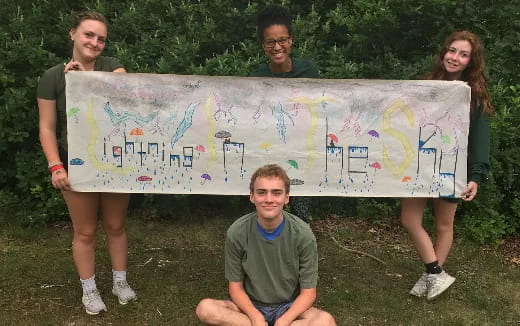 a group of people holding a banner