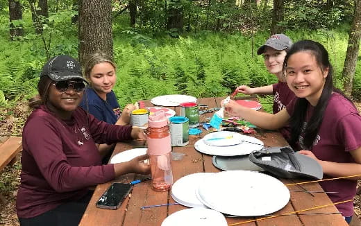 a group of people sitting at a table eating food