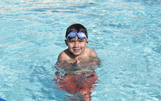 a person wearing goggles in a pool