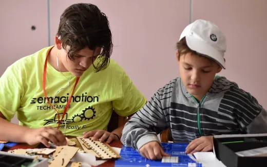 a few young boys working on a project