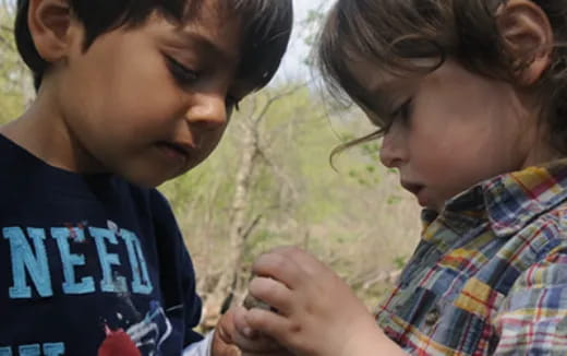 a boy and girl looking at each other