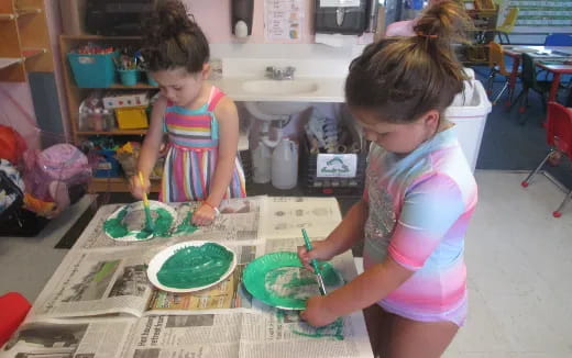 a couple of young girls painting