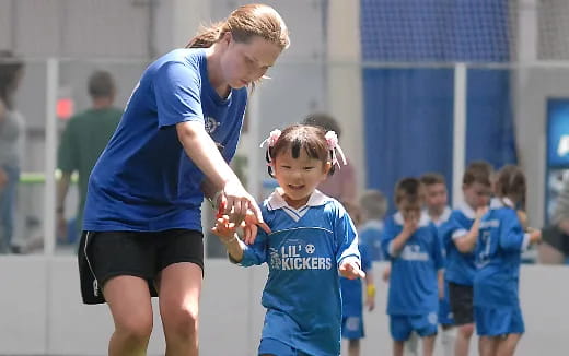 a woman and a child shaking hands
