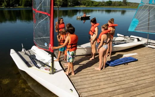 a group of people stand on a dock