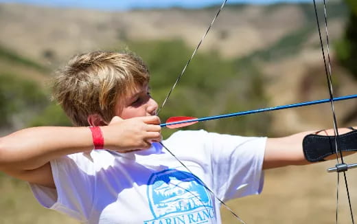 a boy shooting a bow