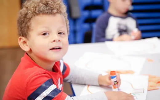 a young boy sitting at a table