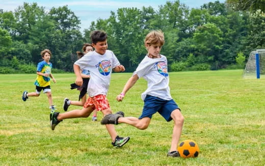 kids chasing a football ball