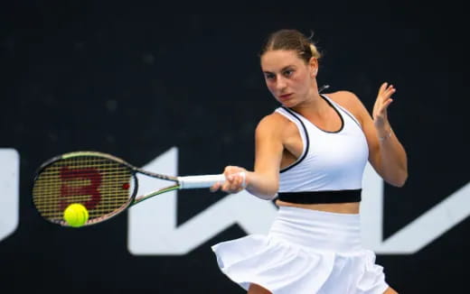 a person hitting a ball with a tennis racket