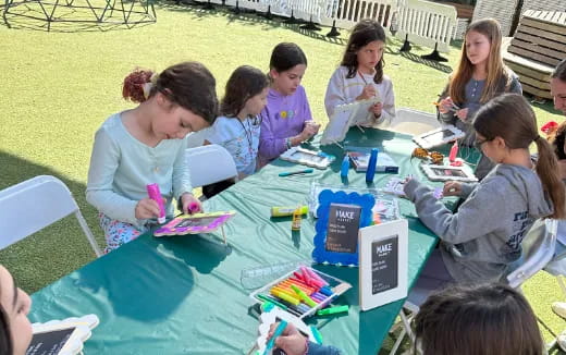 a group of children sitting around a table