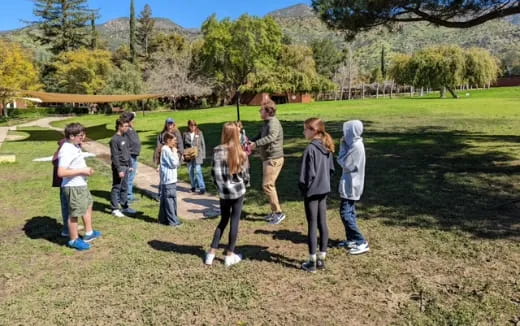 a group of people standing in a field