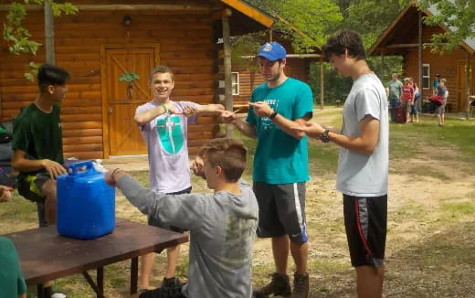a group of people standing around a table outside