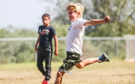 a boy running on a field