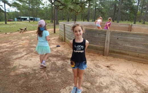 a group of children in a fenced in area