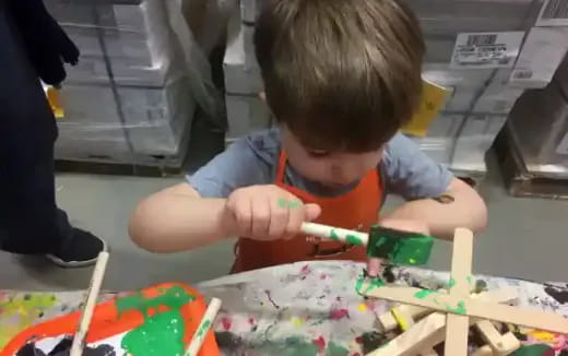 a child painting on a table