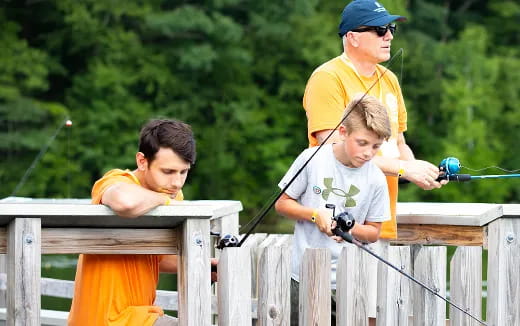 a group of boys playing with a toy gun
