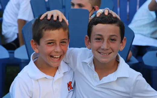 a couple of boys in white shirts